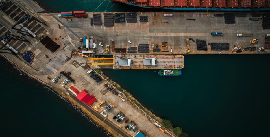 An aerial view of a cargo ship docked at a dock